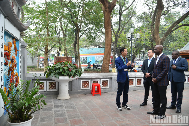 The Togolese Foreign Minister listens to an introduction to Ngoc Son Temple