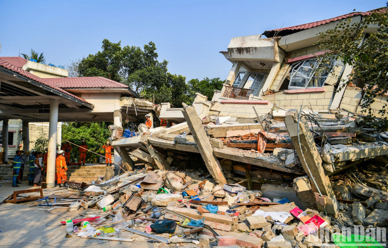 A complete view of the collapsed building following the devastating earthquake.