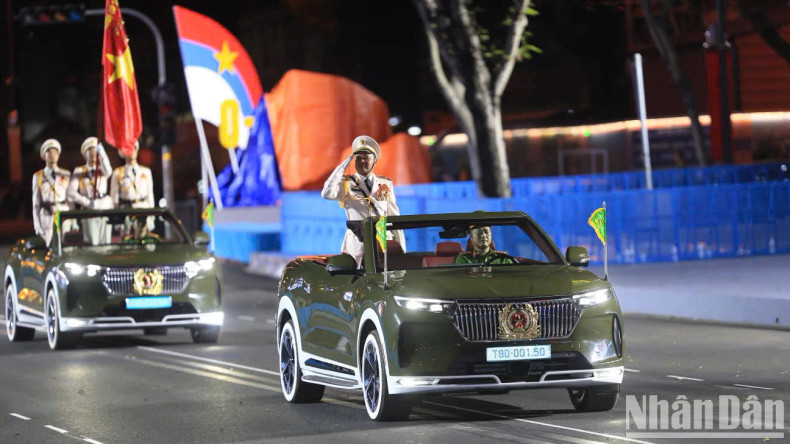 The Vietnam People’s Army marching past the podium, led by a command vehicle carrying senior officers from the Ministry of National Defence.