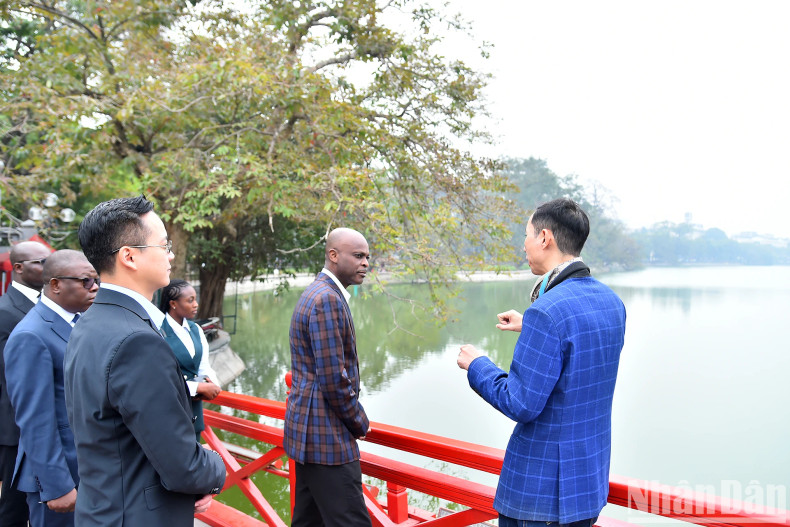 Togolese Foreign Minister Robert Dusse listens to an introduction to the history of Hoan Kiem Lake.