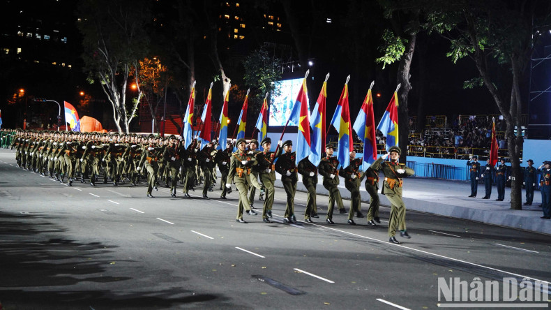 Officers representing the five military wings that entered Saigon on April 30, 1975, march in unison during the parade.