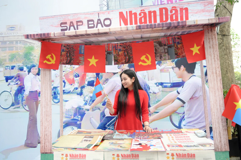 Many young people take the opportunity to check in at Nhan Dan’s display booth.