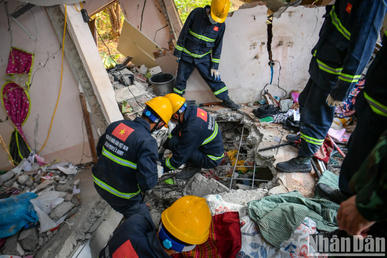 Vietnamese military rescue forces carefully remove each stone to prevent dangerous tremors that could endanger those conducting the mission and to avoid causing further harm to the victim