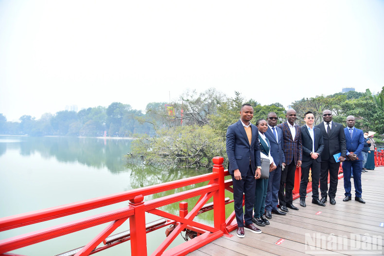 Togolese Foreign Minister Robert Dusse and members of the delegation at The Huc Bridge by Hoan Kiem Lake.