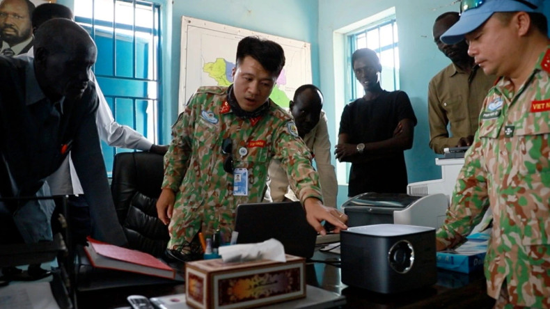 A member of Viet Nam’s Engineering Unit Rotation 3 instructs Abyei Department of Education staff on how to install and operate the donated office equipment. A member of Viet Nam’s Engineering Unit Rotation 3 instructs Abyei Department of Education staff on how to install and operate the donated office equipment.