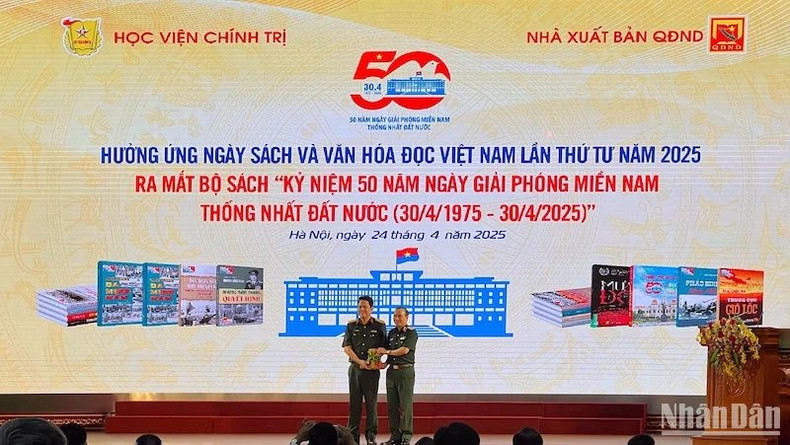 Colonel Pham Van Truong (left), representing the People's Army Publishing House, presents the book series to the Political Academy.