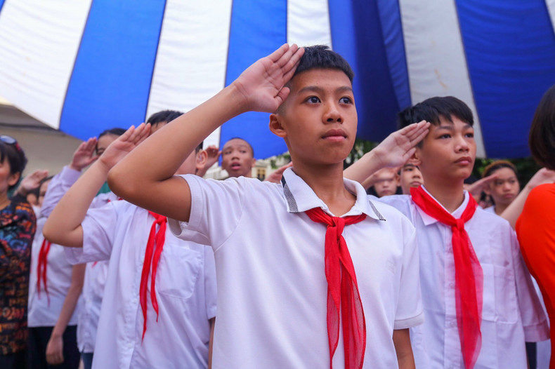 Students saluting the national flag during the new academic year opening ceremony.