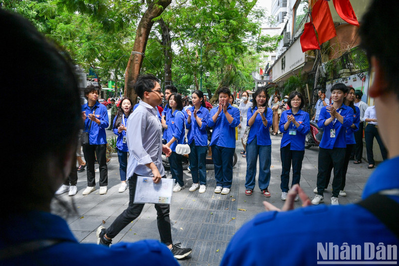 A candidates greeted with applause after finishing the exam. A candidates greeted with applause after finishing the exam.