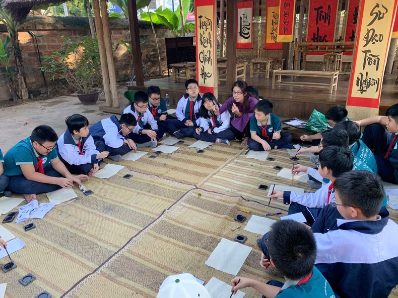 Children try calligraphy writing at the Temple of Literature in Hanoi Children try calligraphy writing at the Temple of Literature in Hanoi