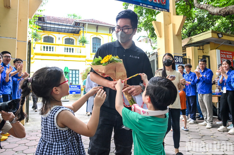 A candidate receives a bouquet of flowers from his relatives after finishing the exam. A candidate receives a bouquet of flowers from his relatives after finishing the exam.
