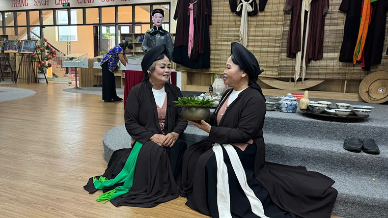 Artisans performing Quan Ho love duet singing in the exhibition space.