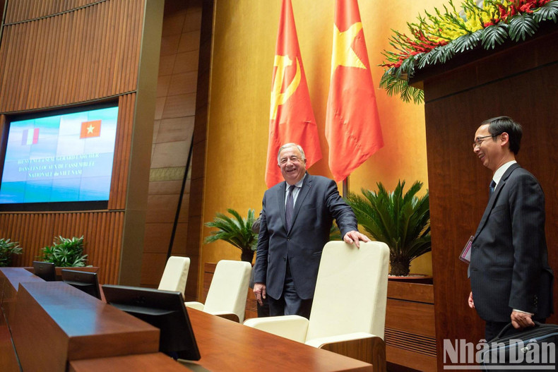 President of the French Senate Gérard Larcher listens to the introduction of Dien Hong Hall.