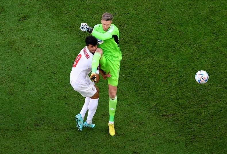 Wales' Wayne Hennessey fouls Iran's Mehdi Taremi leading to a red card. REUTERS/Fabrizio Bensch