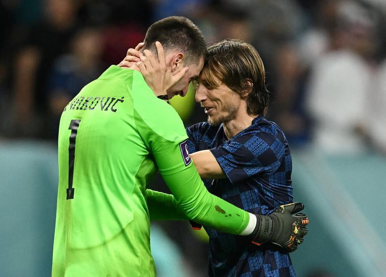 Croatia's Dominik Livakovic and Luka Modric celebrate after winning the penalty shootout as Croatia progress to the quarter finals. REUTERS/Dylan Martinez