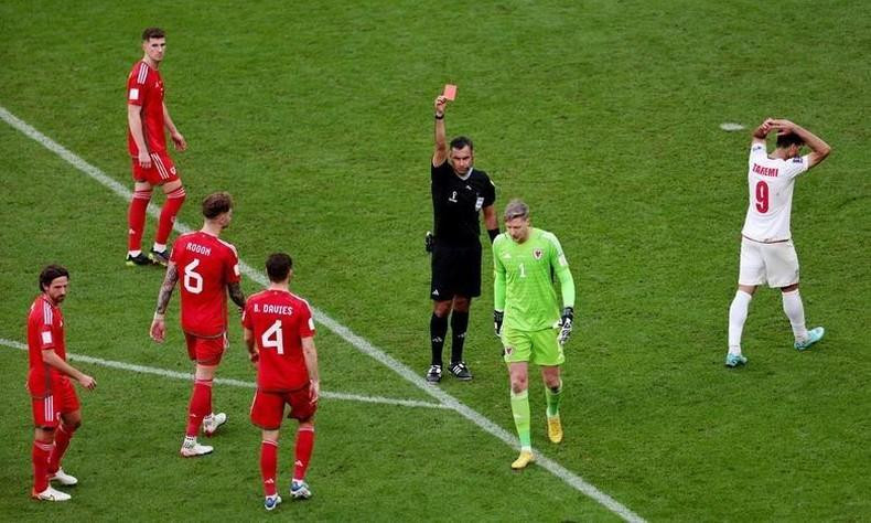 Wales' Wayne Hennessey is shown a red card by referee Mario Escobar. REUTERS/Marko Djurica