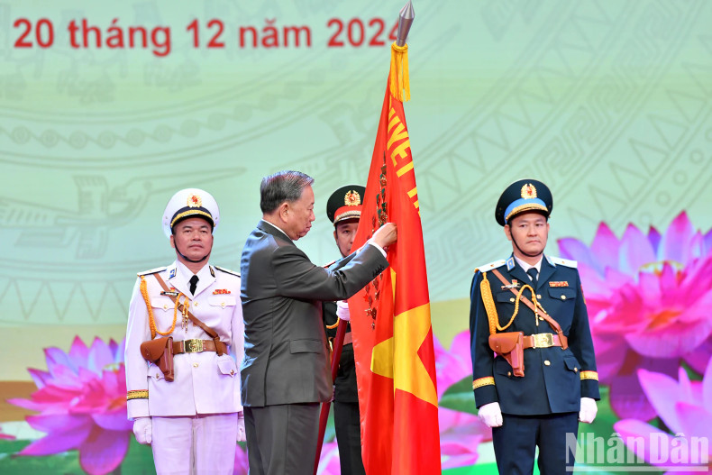 General Secretary To Lam pinning the Ho Chi Minh Medal on the Military Flag. General Secretary To Lam pinning the Ho Chi Minh Medal on the Military Flag.