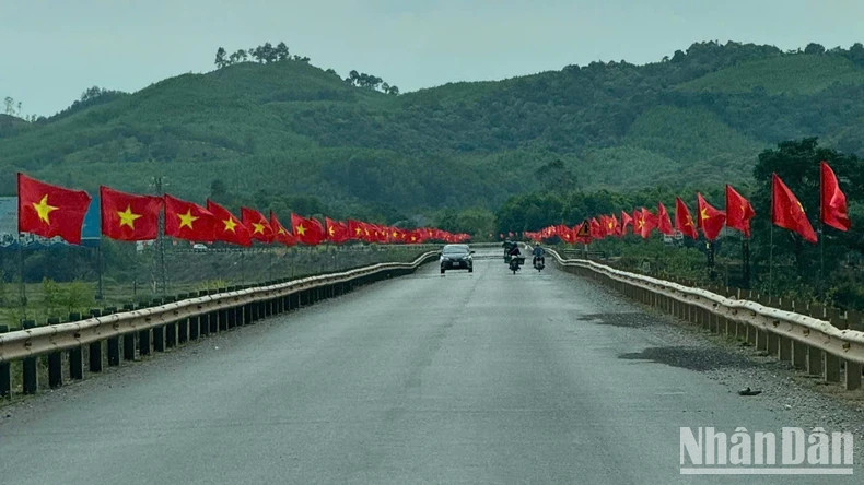 Road adorned with national flags on the way to Phong Nha Cave, Quang Binh Province. Road adorned with national flags on the way to Phong Nha Cave, Quang Binh Province.