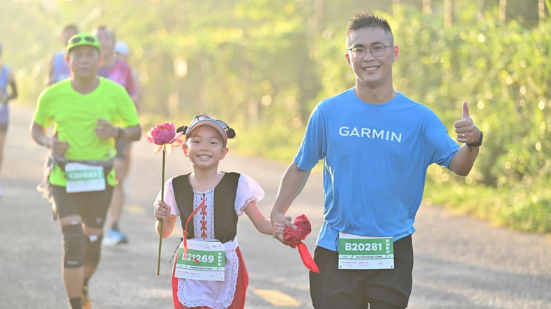 A girl carries a lotus flower during her run.