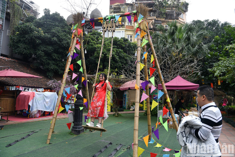 A girl playing swing at a folk game space.