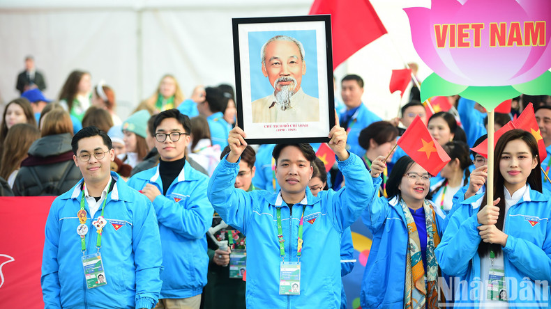 A member from the Vietnamese delegation raising high a portrait of President Ho Chi Minh at the event. A member from the Vietnamese delegation raising high a portrait of President Ho Chi Minh at the event.