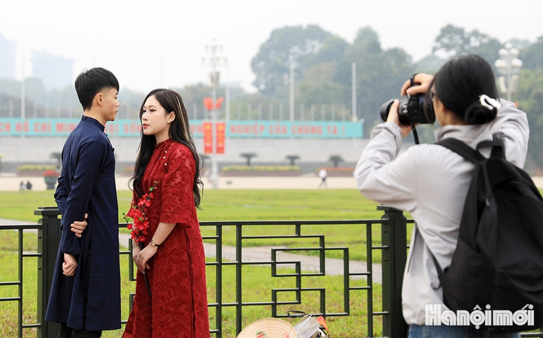 A young couple dressed in Ao Dai are spotted taking pictures at Ba Dinh Square A young couple dressed in Ao Dai are spotted taking pictures at Ba Dinh Square