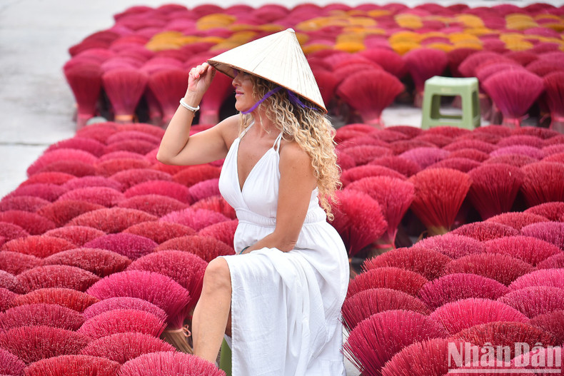 A foreign tourist check-in at the Quang Phu Cau incense village.
