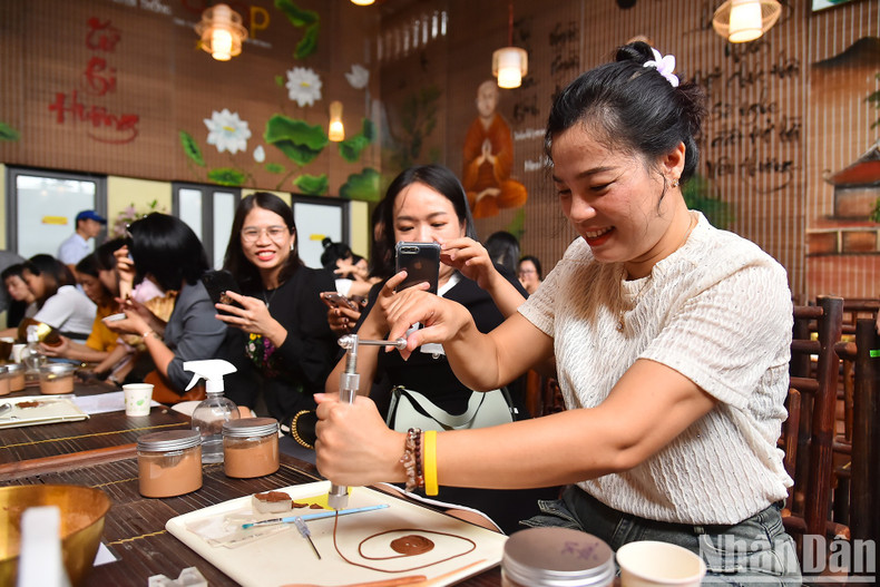 A visitor tries her hands at making incenses.