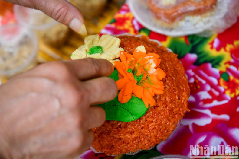 Careful hands of artisans with a traditional plate of sticky rice.