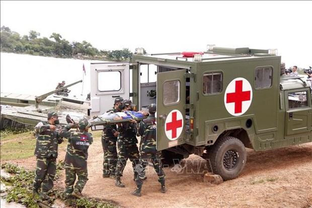 Military officers are putting a fake victim on an ambulance at the scene of the drill. (Photo: VNA)