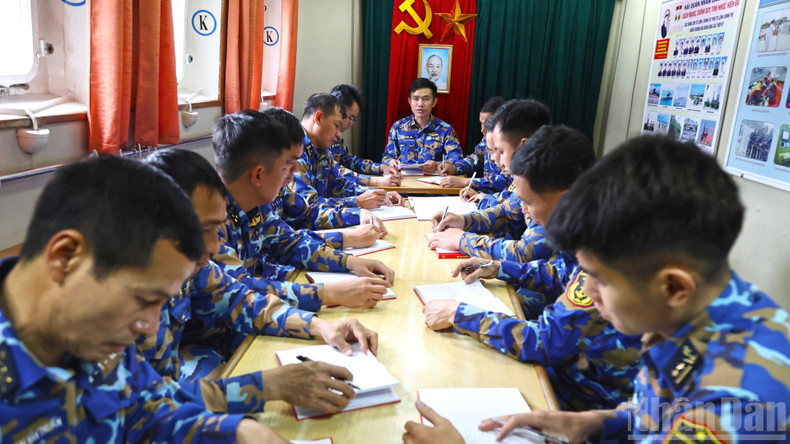 Major Ngo Quoc Hoi, political officer of Ship 267, chairs a Party meeting while the vessel is on mission at sea.