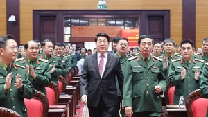 State President Luong Cuong (in black suite) attends the national political-military conference in Ha Noi on December 17. (Photo: VNA)