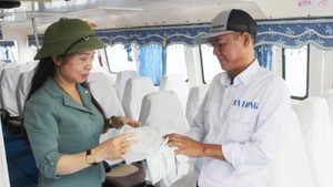 Tourists exchange single-use plastic bags for safe biodegradable ones at the passenger port before travelling to Co To island.