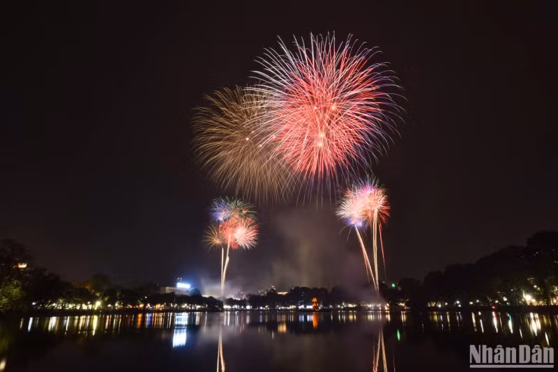 Fireworks bloom in the night sky of Hanoi.