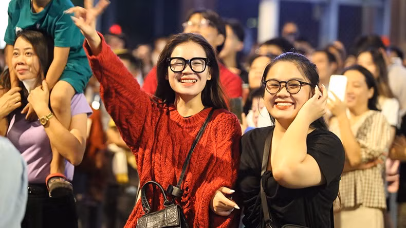 Young people eagerly await the fireworks display to celebrate the National Day