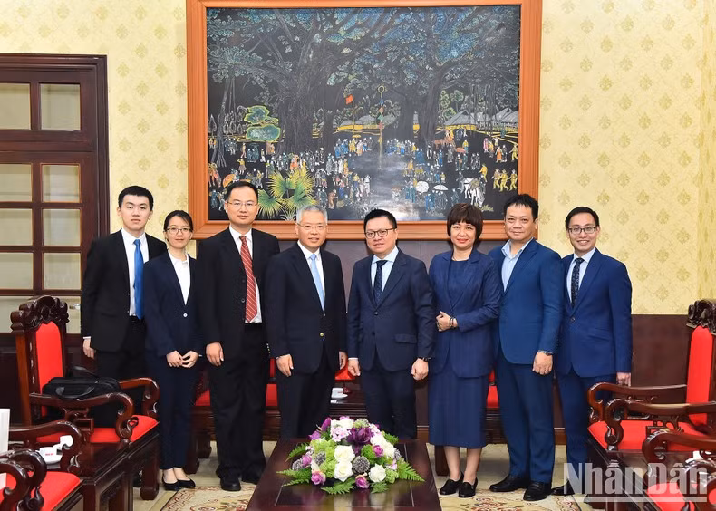 Le Quoc Minh, Hu Zhaoming and other delegates pose for photos after the meeting.