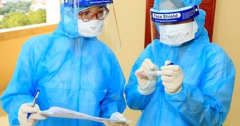 A health worker collects sample for COVID-19 testing 