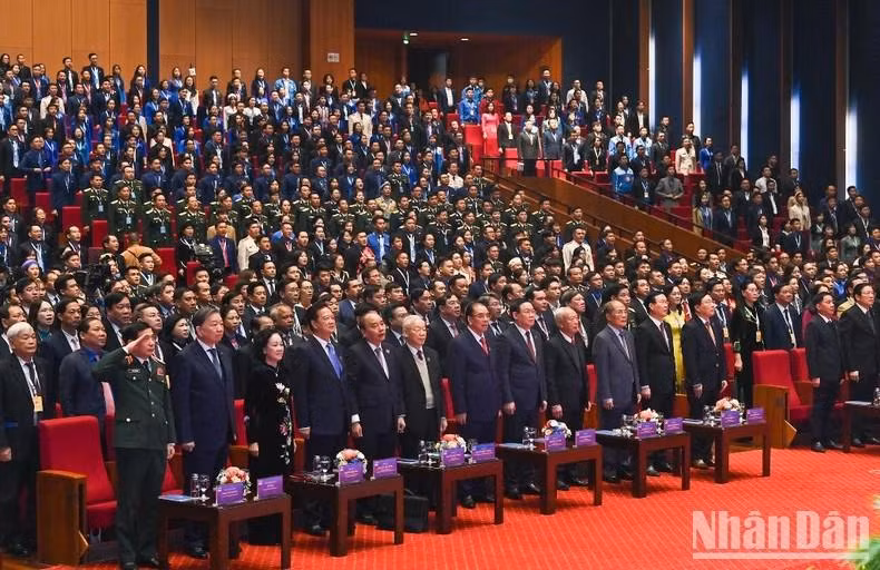 Delegates observe the flag-raising ceremony.