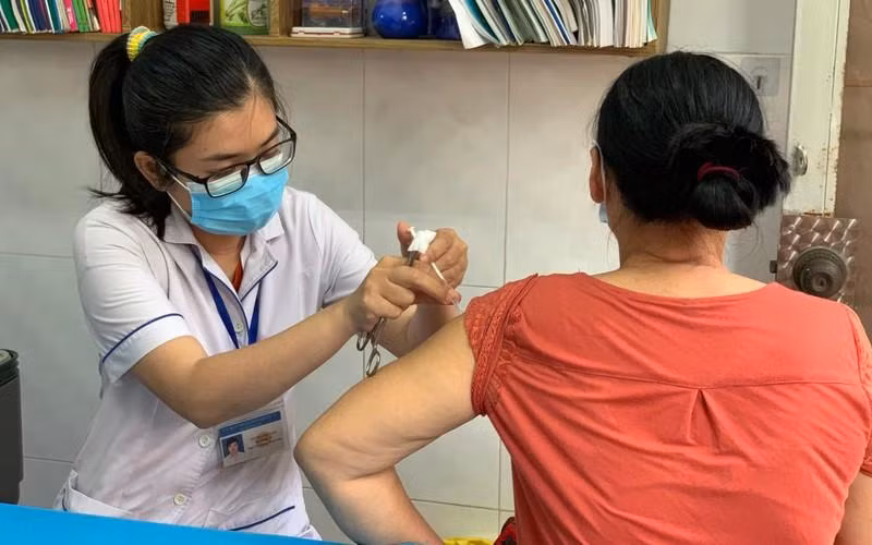 A woman gets vaccinated against COVID-19.