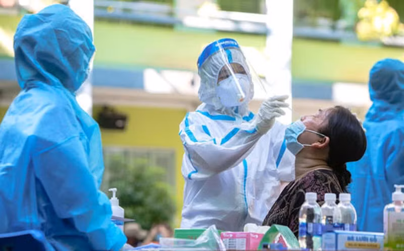 A health worker collects sample for COVID-19 testing.