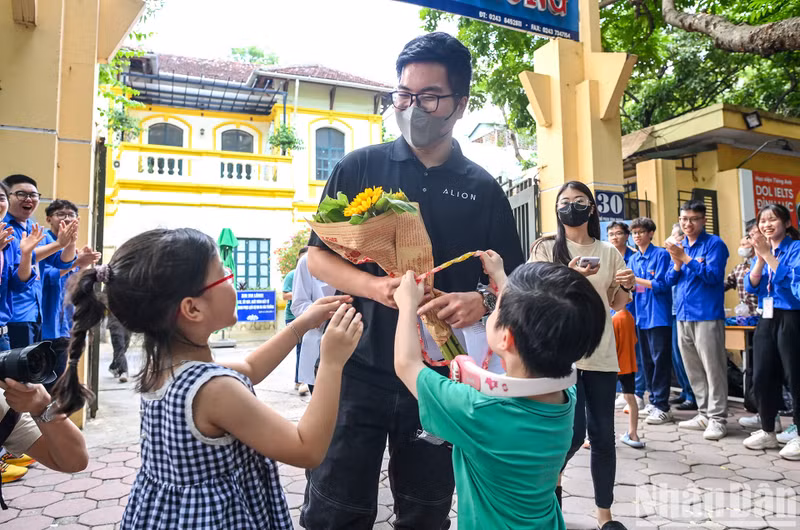 A candidate receives a bouquet of flowers from his relatives after finishing the exam. A candidate receives a bouquet of flowers from his relatives after finishing the exam.