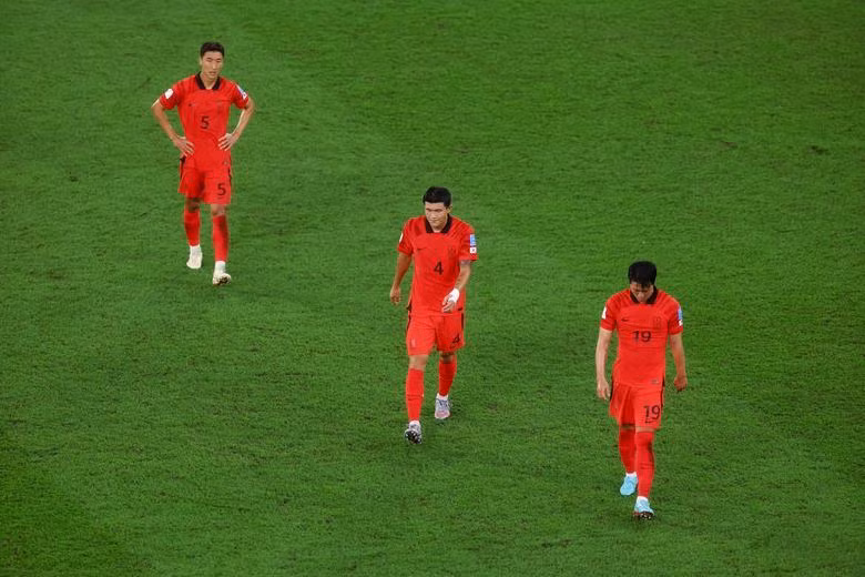 South Korea's Kim Young-gwon, Kim Min-jae and Jung Woo-young look dejected as they walk off at half time. REUTERS/Paul Childs