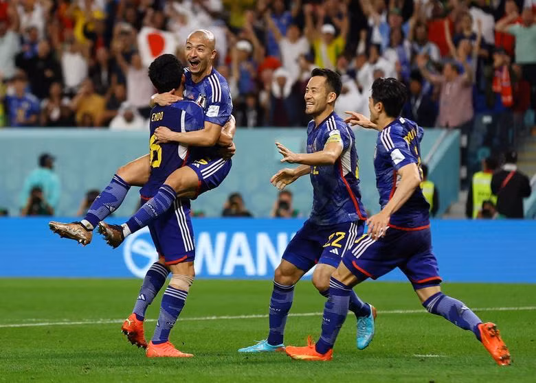 Japan's Daizen Maeda celebrates scoring their first goal with Wataru Endo. REUTERS/Matthew Childs