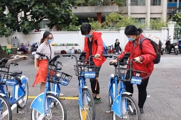 Young people use the public bicycle-sharing service in HCM City. The service has received positive feedback from locals so far. (Photo: VNA)