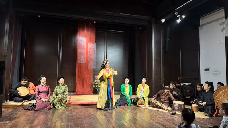 Performing traditional arts in the Hanoi's Old Quarter space.