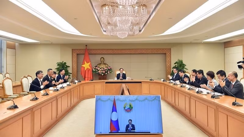Deputy PM, FM holds online talks with Lao counterpart (Photo: VGP)