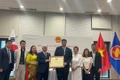 VFFCC President Do Van Chien presents a certificate of merit to the VKBIA collective. (Photo: VKBIA)