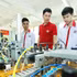 Students in an industrial electronics class practise on an automation model at Ha Noi High-Tech Vocational College.