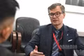 Evgeny Vlasov addresses a reporter from Nhan Dan Newspaper. (Photo: THANH TRAI)