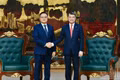 Prime Minister Le Minh Hung (right) reveives Lao Deputy Prime Minister and Minister of Finance Santiphab Phomvihane in Ha Noi on August 28 (Photo: NDO)