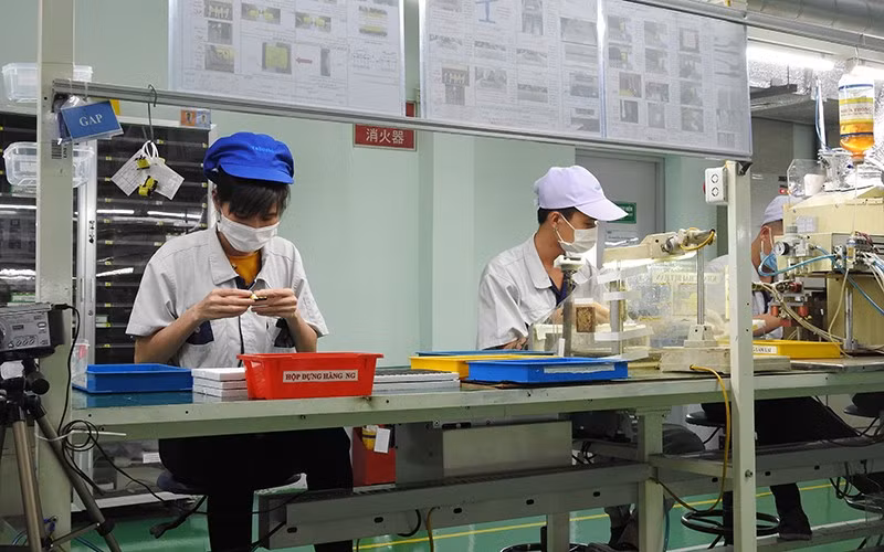 Workers assemble products at Vietnam Tabuchi Electric in Bac Ninh Province.